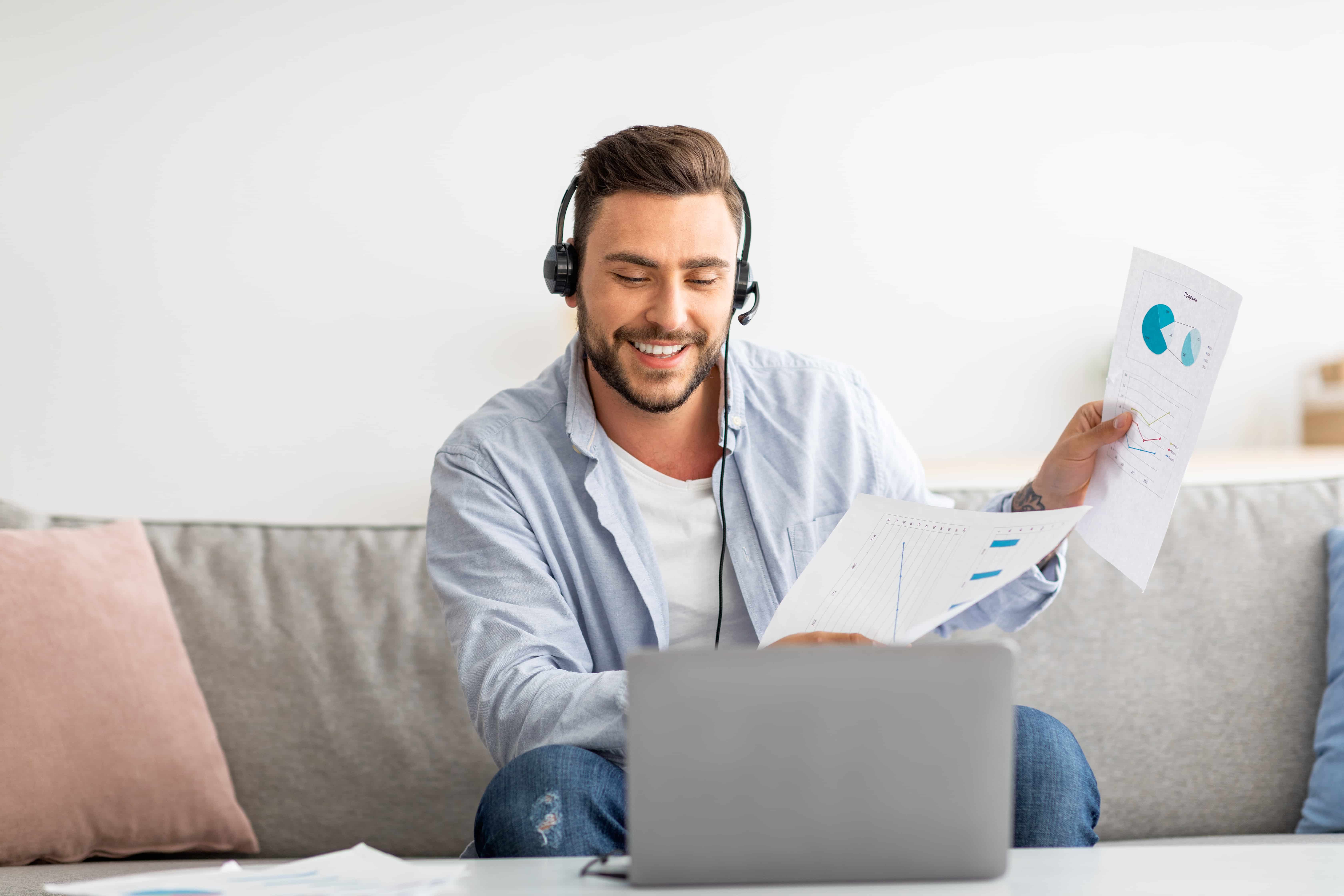 Man on headset pointing at screen