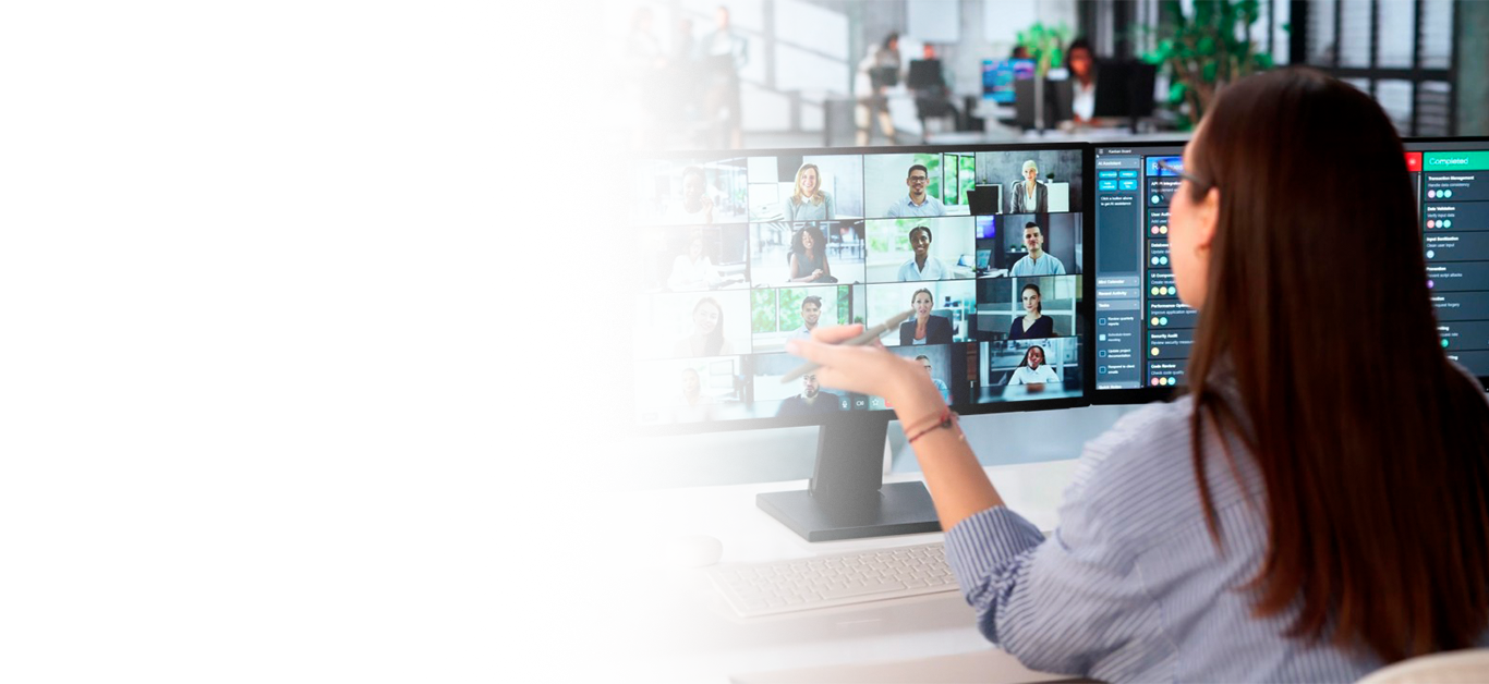 Woman working on multiple monitors